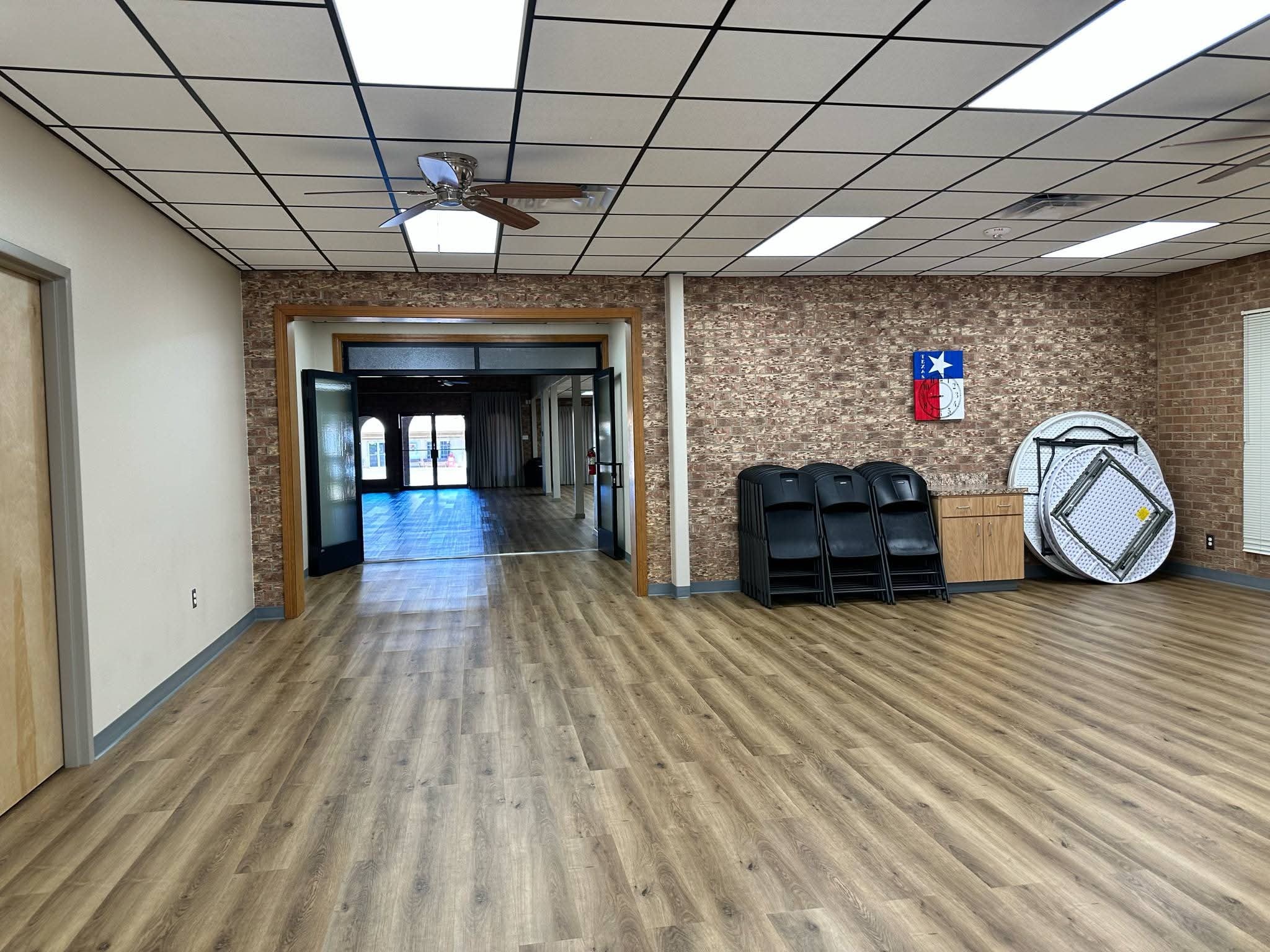 Senior Center main hall with wood flooring and Texas flag decor