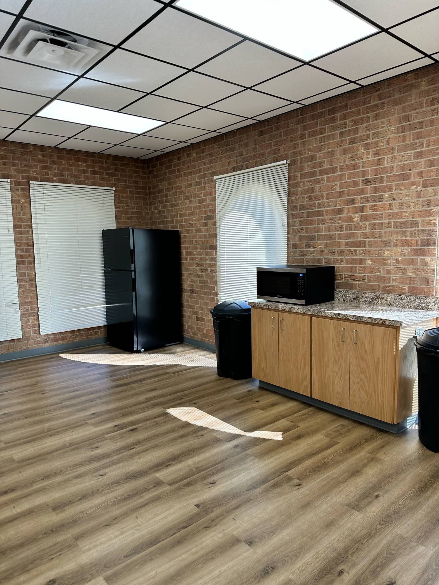 Senior Center open room with brick walls and ceiling fan